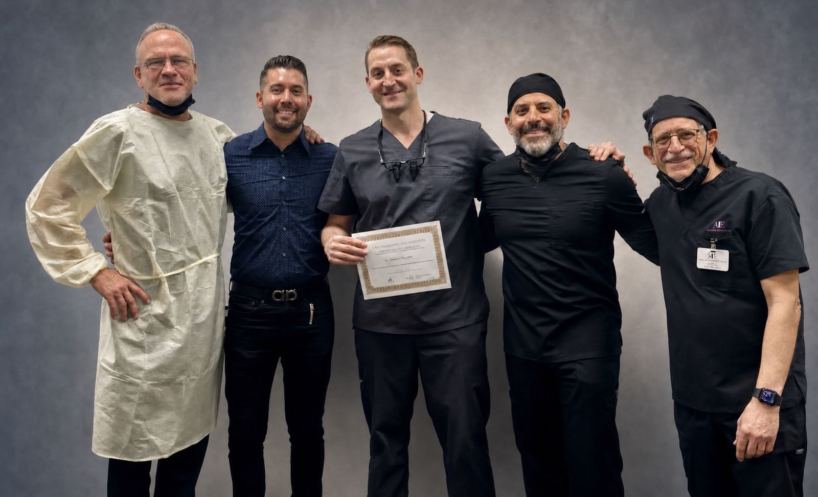 Five dental professionals celebrating the completion of advanced implant education